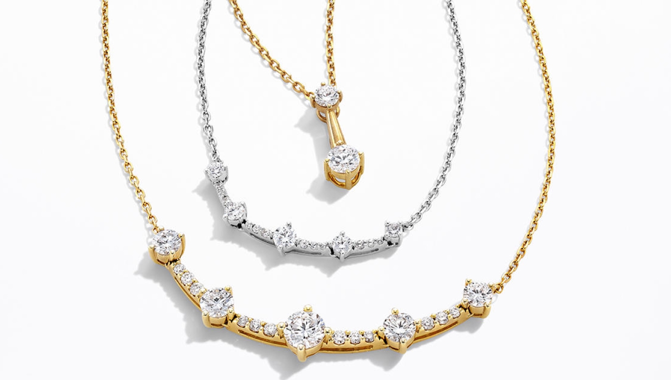 A variety of gold and silver stacking necklaces
