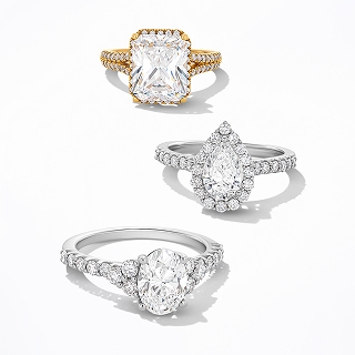 Three diamond engagement rings. One with a gold band and two with silver bands.