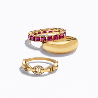 Three gold rings, one studded with amethysts, and the others with diamonds.