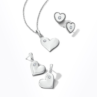 A collection of white, heart shaped pendants in earring and necklace form.