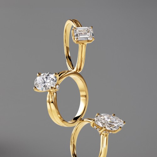 Three gold solitaire rings stacked vertically