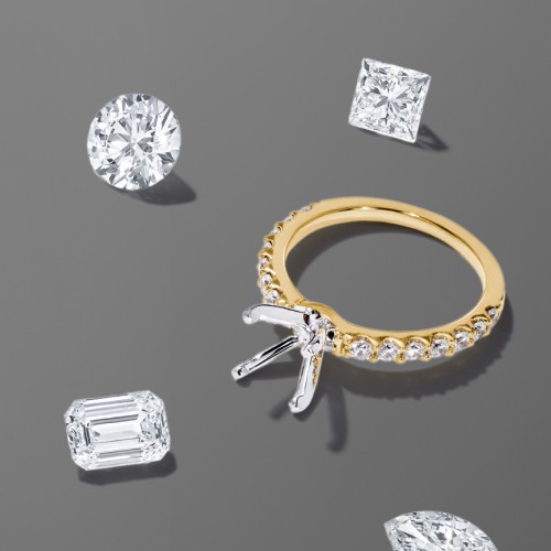 Engagement ring and setting surrounded by several loose diamonds