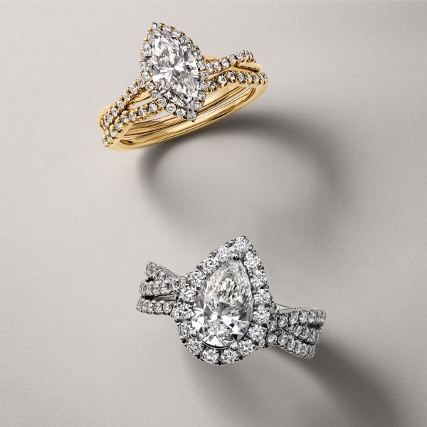 Gold marquise engagement ring above white gold pear engagement ring