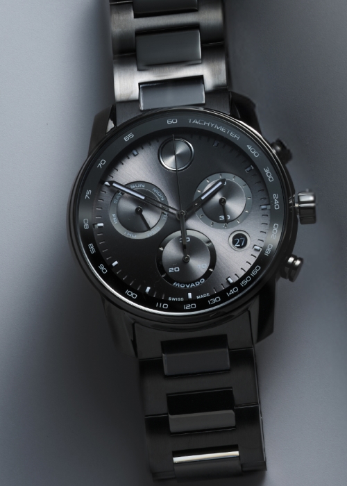 A gray and black chrome Movado watch.