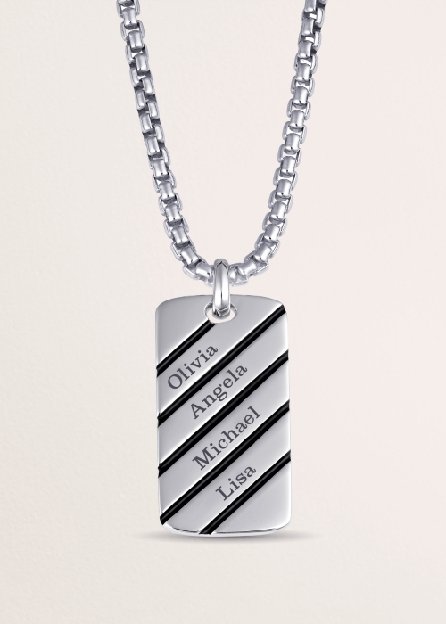 A personalized, name-engraved, silver pendant on a silver chain.