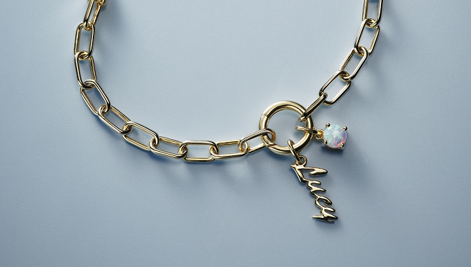 A gold chain with an engraving pendant by KAY,