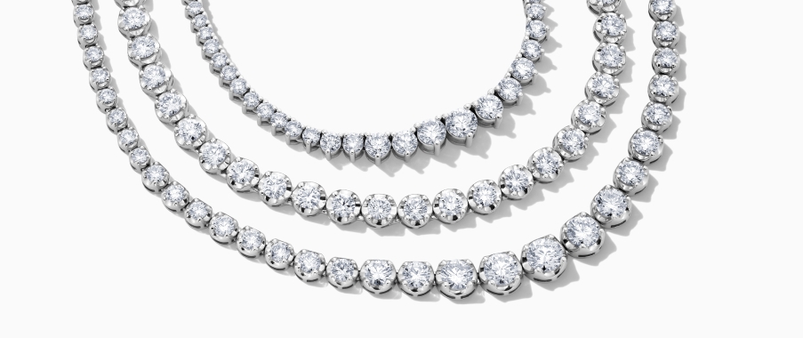 A set of three diamond stacking necklaces.