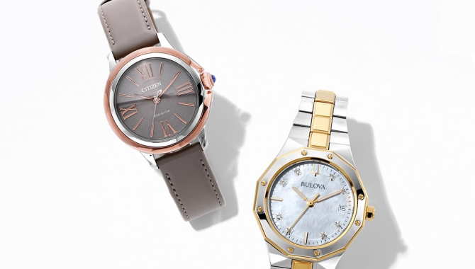 Woman wearing blue Coach watch with several bracelets