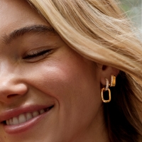 woman wearing gold earrings