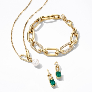 Woman wearing layered STUDIO BY KAY necklaces