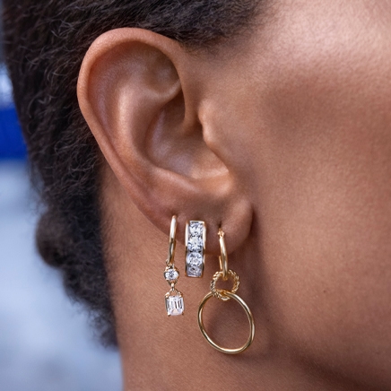 Woman's ear layered with beautiful lab-grown diamond earrings