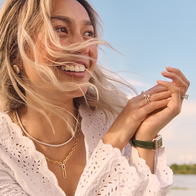 Woman wearing beautiful gold and diamond jewelry from KAY.