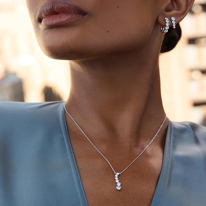 A woman wearing a diamond necklace.