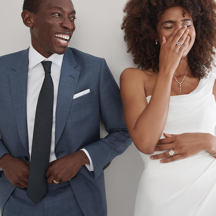 Bride and groom laughing and wearing jewelry from KAY