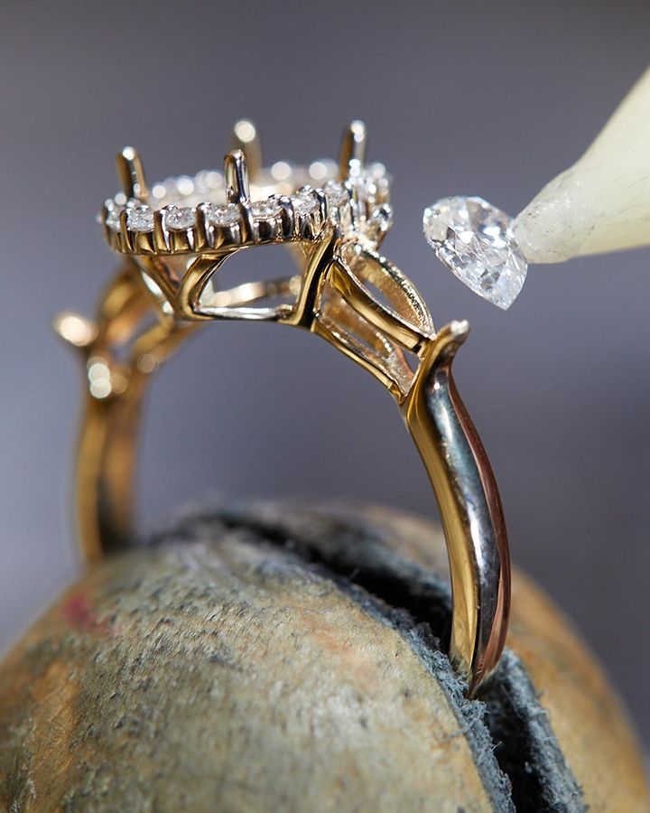 Engagement ring being set with diamond from KAY