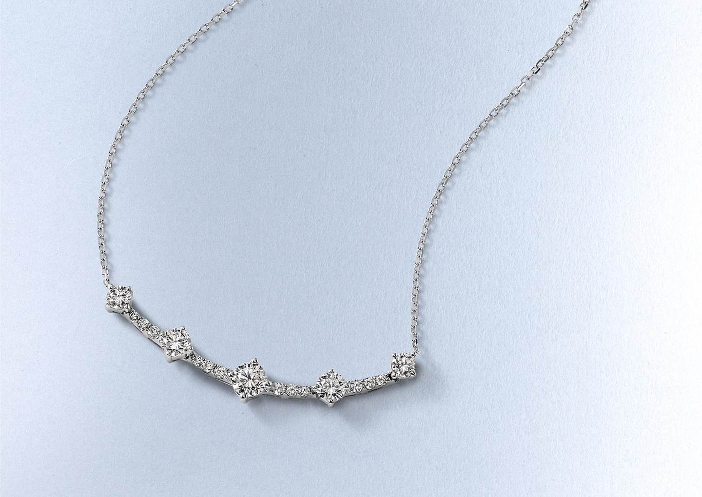 Kay diamond station necklace featuring five round brilliant diamonds connected by a delicate white gold chain, showcasing timeless elegance and everyday diamond sparkle.