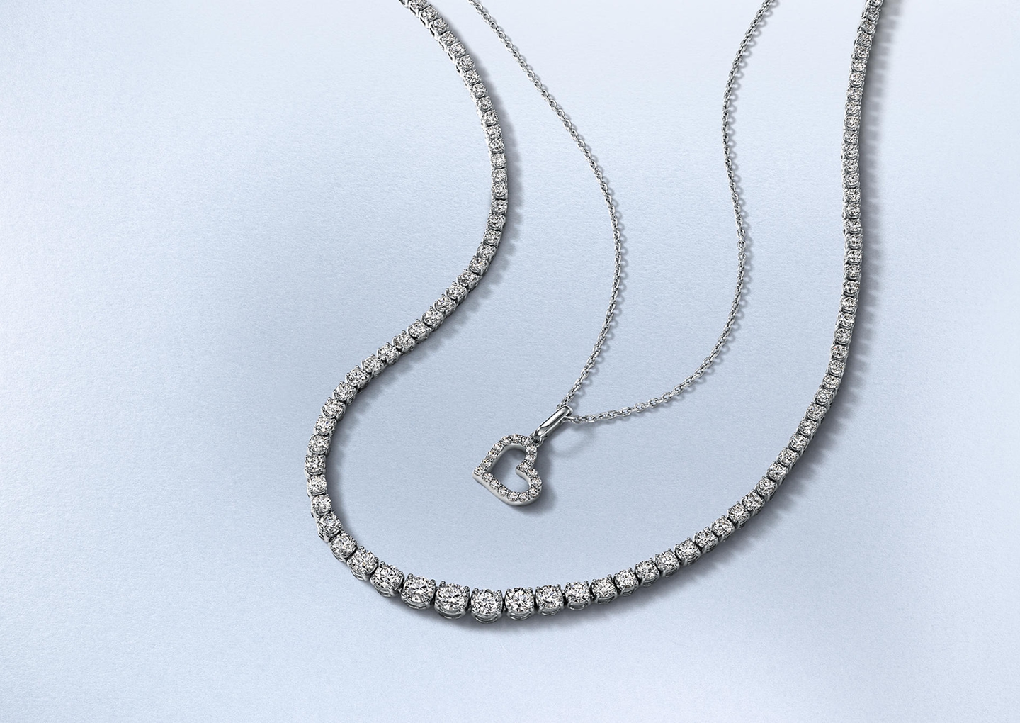Kay diamond tennis bracelet paired with a diamond engagement ring and layered diamond necklace, showcasing radiant fine jewelry with timeless sparkle in an elegant lifestyle setting.