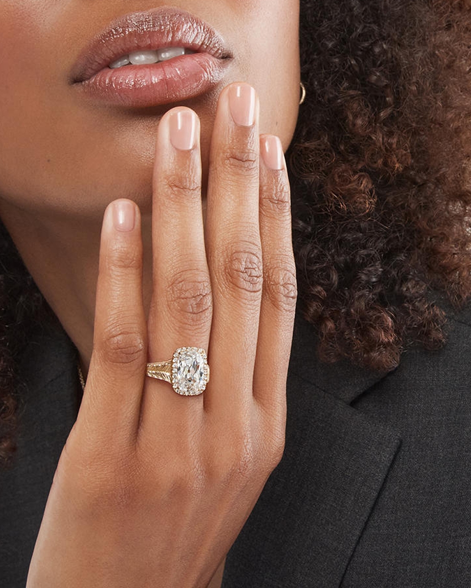 Woman wearing diamond engagement ring from KAY