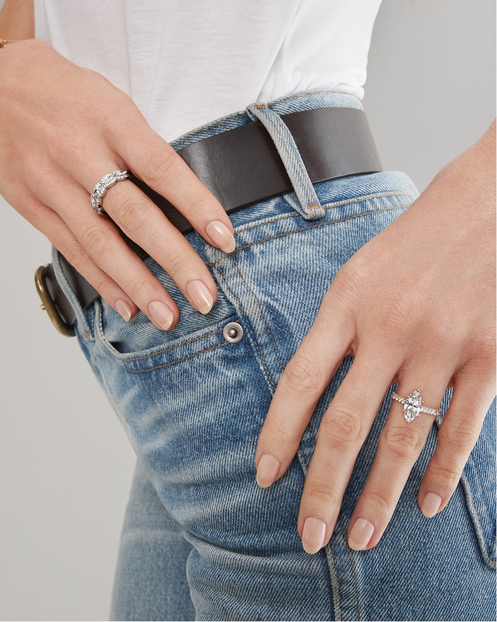 Woman wearing jeans showing off her LEO engagement ring 