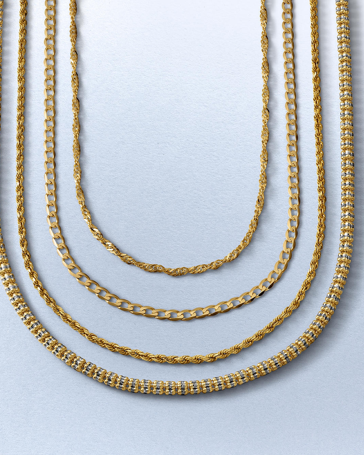 Layered gold and metal chains from KAY