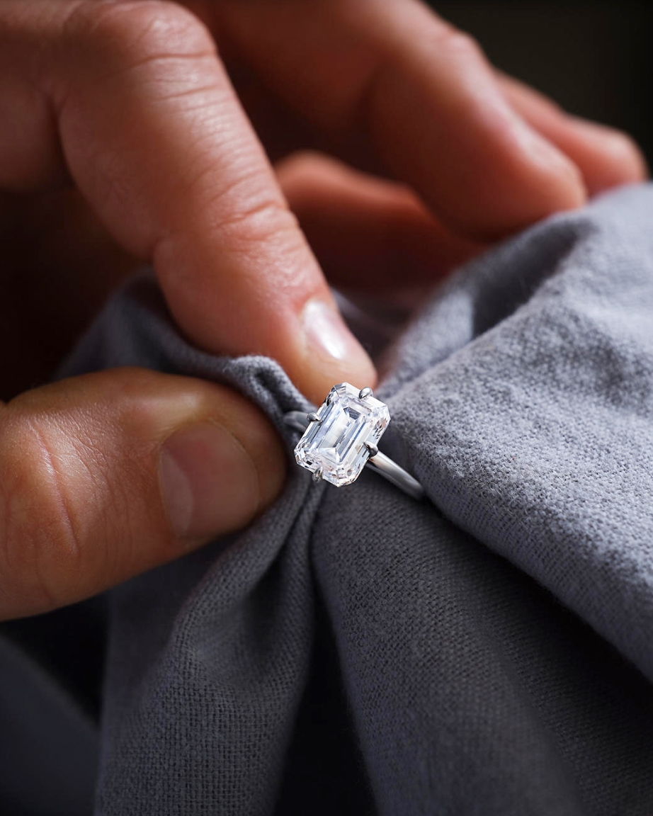 Man cleaning diamond ring from KAY