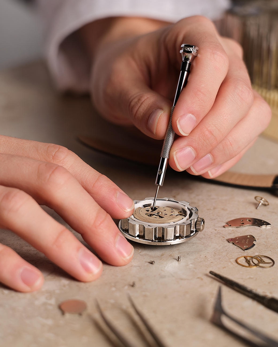 Jeweler repairing watch