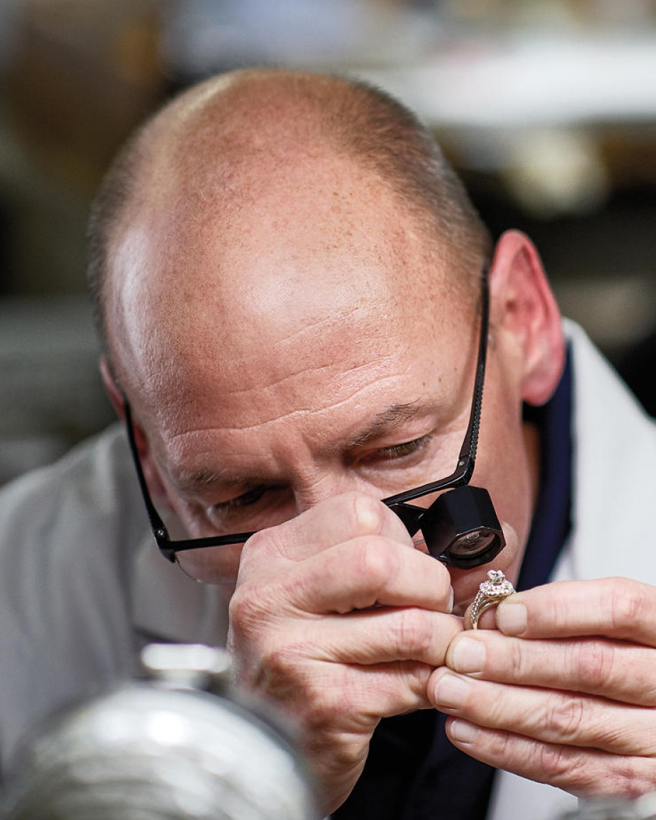 Jeweler inspecting engagement ring