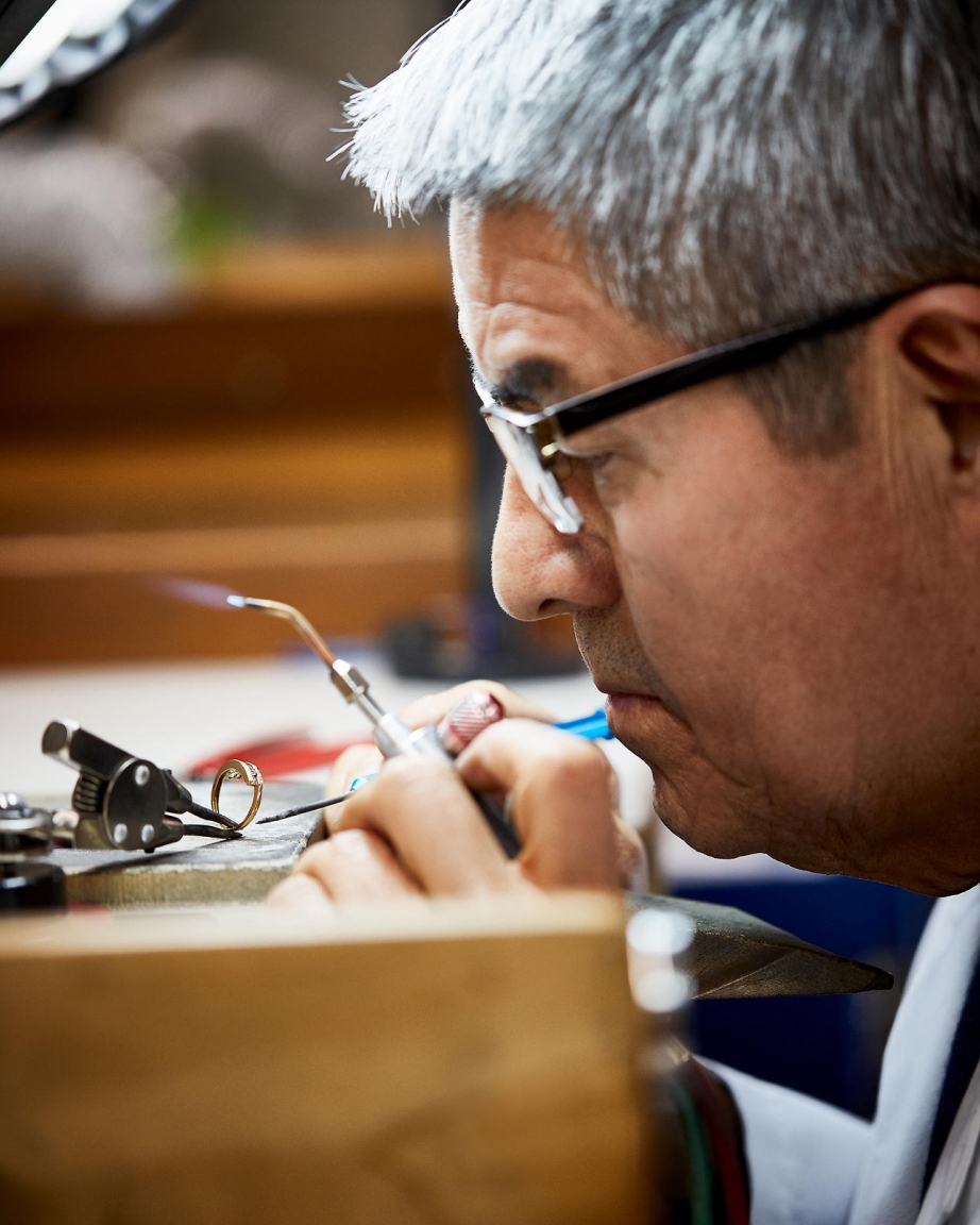 Jeweler working on ring with a jewelers torch