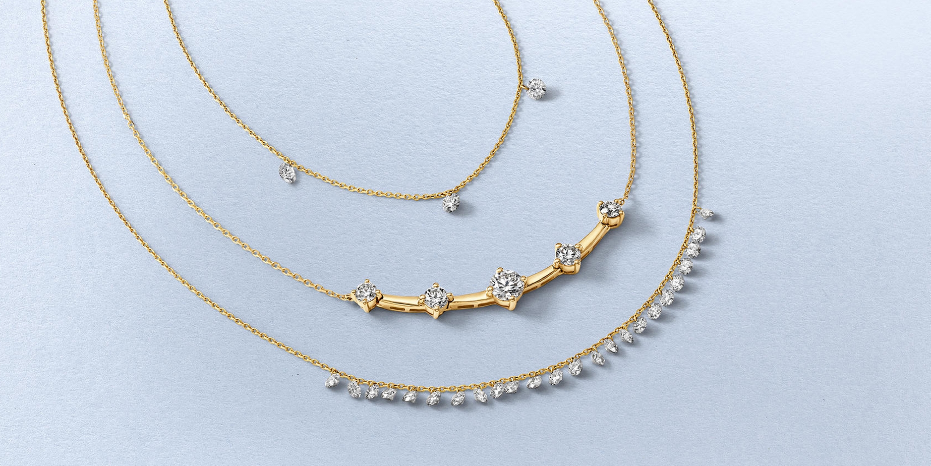 Layered dainty diamond and gold jewelry from KAY