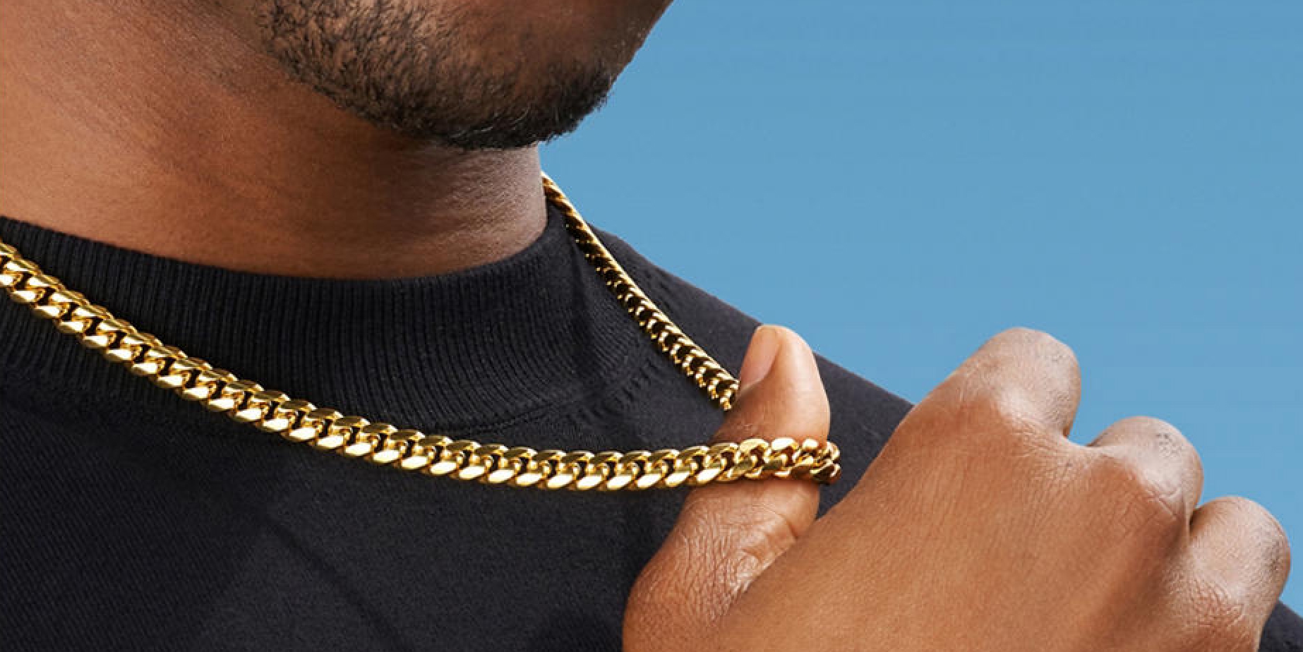 Man wearing gold JAXXON chain necklace and bracelet from KAY