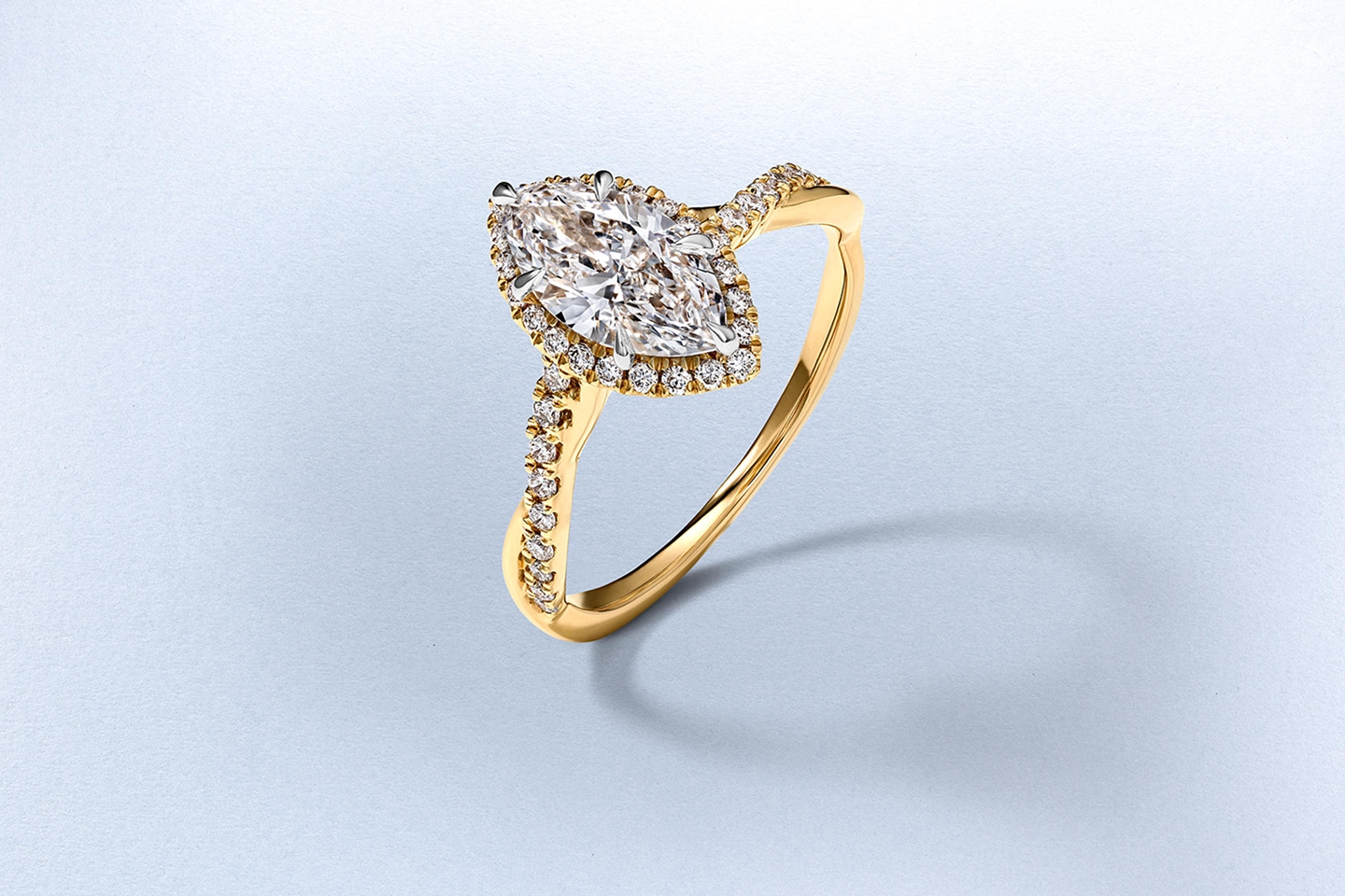 A diamond-inlaid, gold halo engagement ring from KAY.