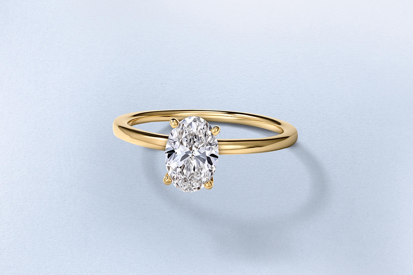Two gold, diamond solitaire engagement rings from KAY.