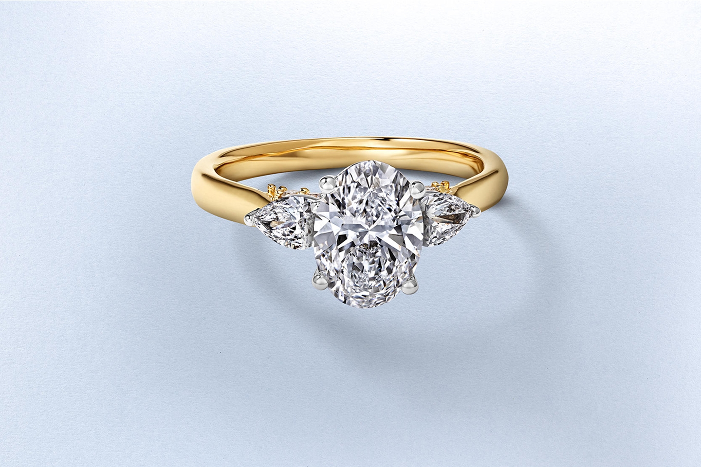 A gold, three-stone, diamond engagement ring from KAY.