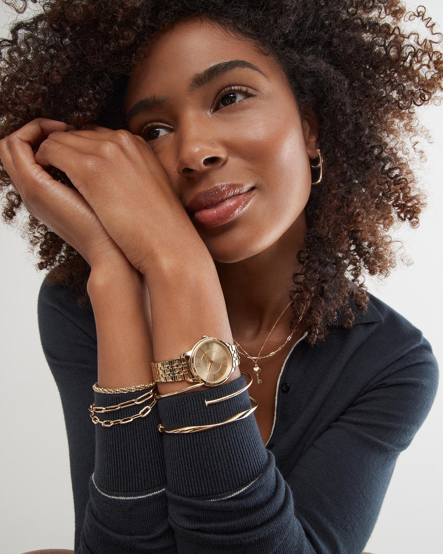 Kay men's gold jewelry featuring a curb chain necklace, link bracelet and gold-tone watch, showcasing modern everyday style and classic craftsmanship.