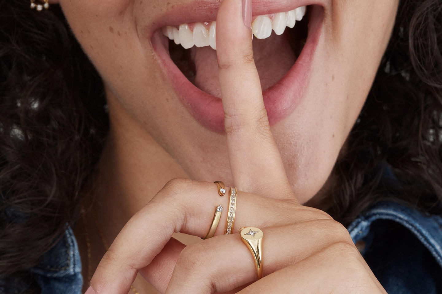 Woman wearing different gold rings from KAY