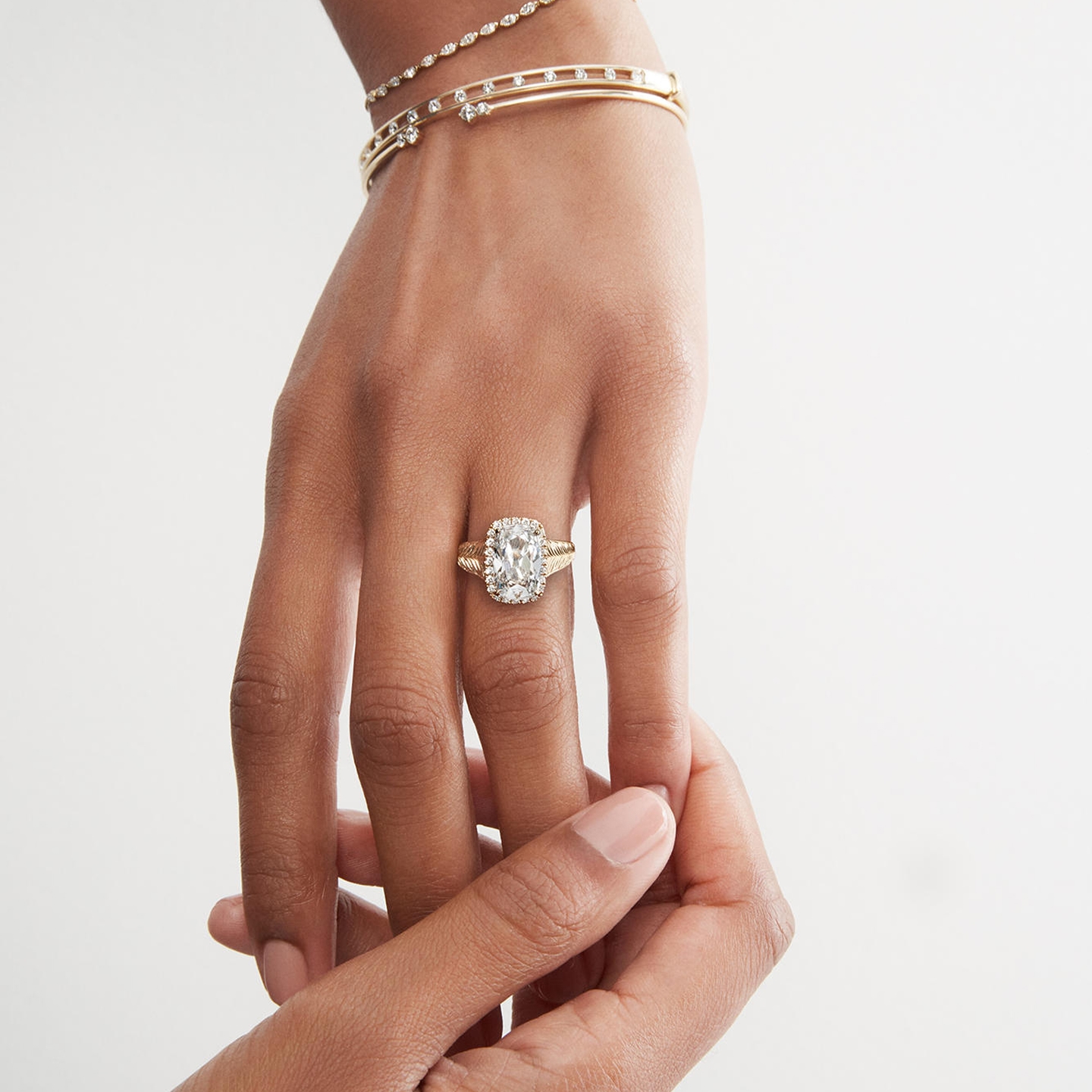 Woman wearing large carat diamond ring from KAY