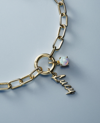 Image of gold necklace with name Lucy and opal charms