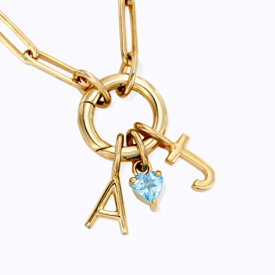 Image of necklace with A and J and blue gemstone charms