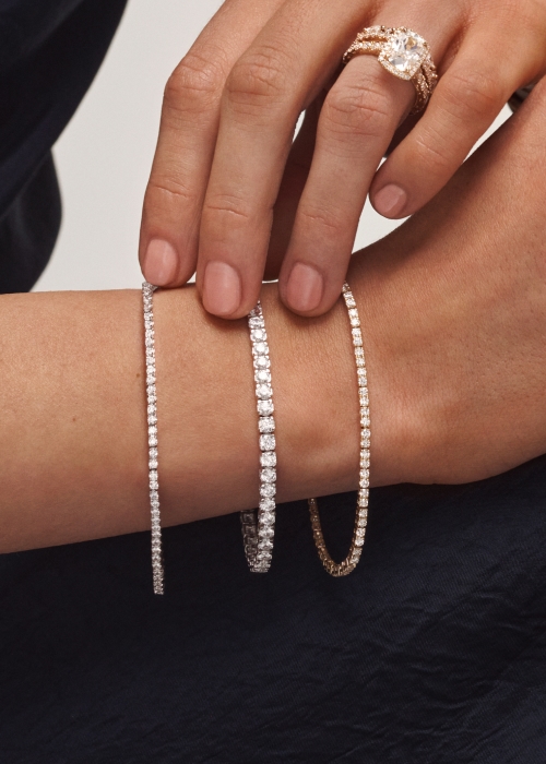 Image of wrist with three tennis bracelets