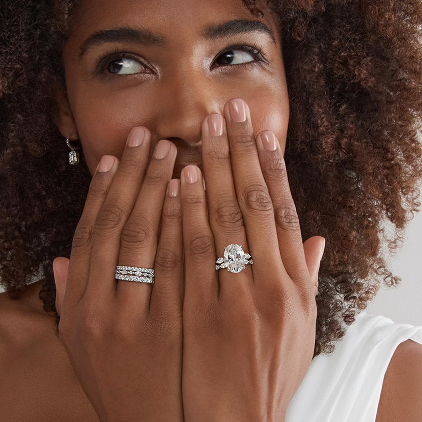 A woman wearing a Neil Lane diamond engagement ring