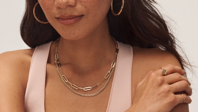 Woman wearing beautiful gold and diamond jewelry from KAY.