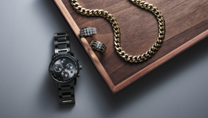 A steel band men's watch and gold chain from KAY.