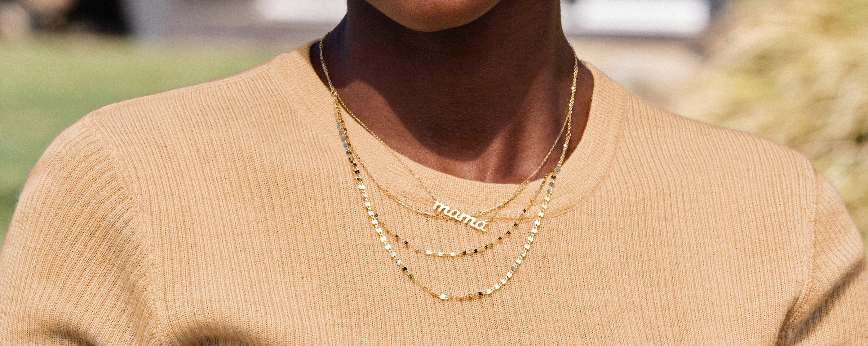Woman wearing gold custom mama necklace