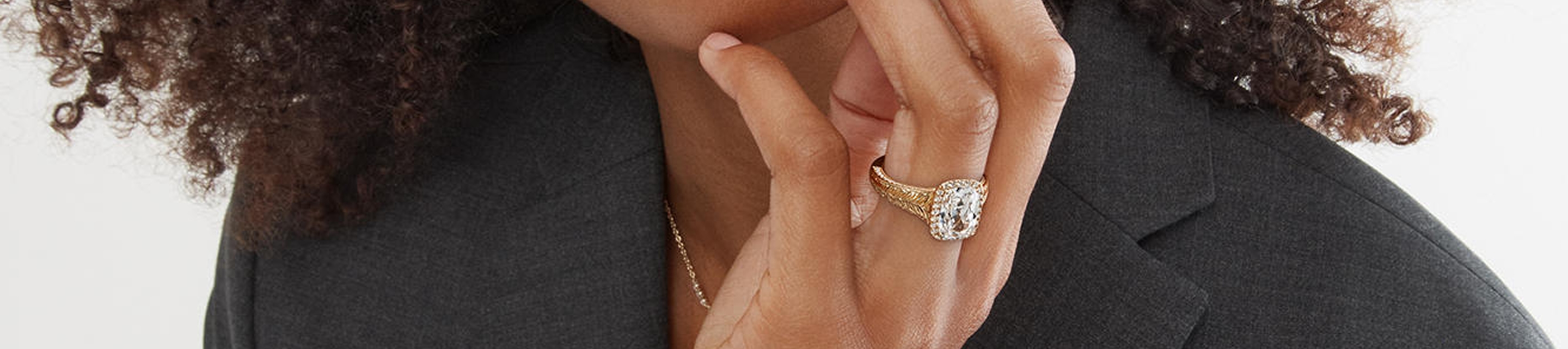 Woman wearing Neil Lane Artistry gold diamond engagement ring