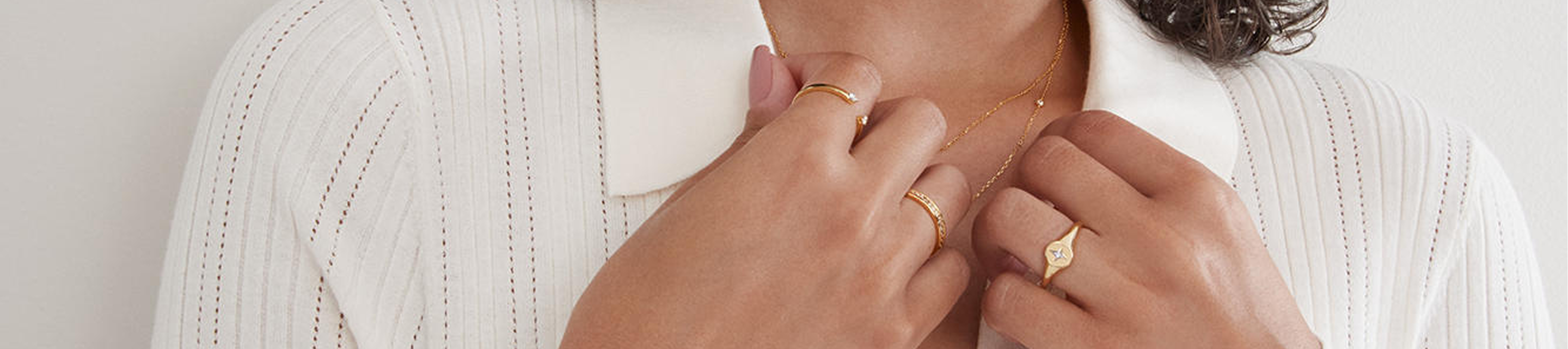 Close up of Rocksbox gold necklaces and rings