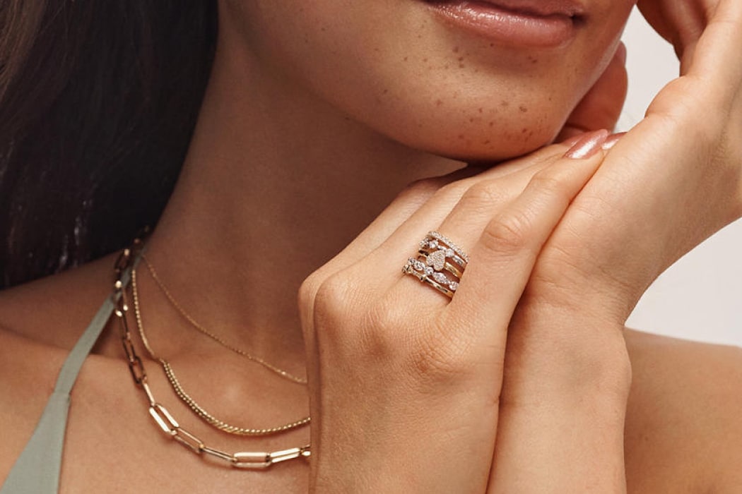 Woman wearing graduation jewelry gifts from KAY