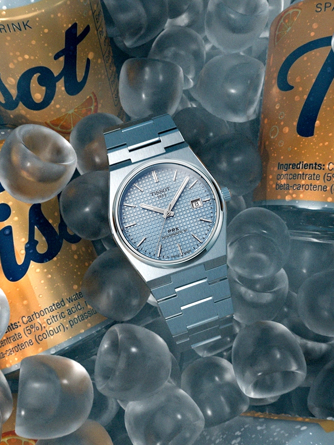 Tissot PRX watch surrounded by ice and drink cans
