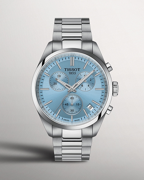Tissot PR100 watch with light blue watch face on gray background