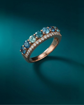 Multi-stone aquamarine and blue gemstone band ring with diamond accents in warm gold, showcasing vibrant color, dimensional sparkle, and contemporary fine jewelry styling for Kay.