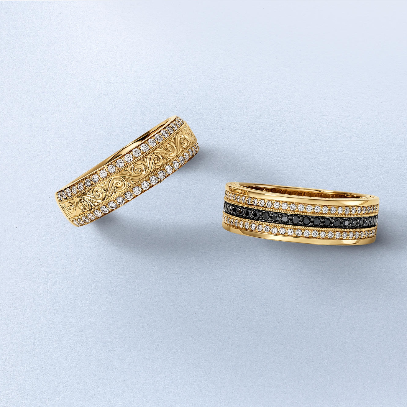 Kay Neil Lane men's wedding bands in yellow gold featuring intricate engraved detailing, white diamonds, and black diamonds, showcasing bold design, luxury craftsmanship, and signature designer style.